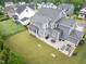 Aerial view showcases a sprawling backyard with a patio and outdoor seating areas at 320 Chickasaw Plum Dr, Holly Springs, NC 27540