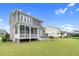 Spacious backyard with patio, screened porch, and lush green lawn at 320 Chickasaw Plum Dr, Holly Springs, NC 27540