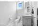 Bathroom featuring a modern vanity, neutral tones, and a window with a view at 320 Chickasaw Plum Dr, Holly Springs, NC 27540