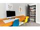 Bedroom area featuring a custom desk and organized storage closet perfect for work or play at 320 Chickasaw Plum Dr, Holly Springs, NC 27540