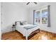 Cozy bedroom with bright windows, hardwood floors, and a ceiling fan at 320 Chickasaw Plum Dr, Holly Springs, NC 27540