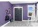 Cozy bedroom with purple walls, guitars displayed, and comfortable hanging chair near a window at 320 Chickasaw Plum Dr, Holly Springs, NC 27540