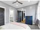 Spacious bedroom featuring a modern ceiling fan, a dresser, and an ensuite bathroom for convenience at 320 Chickasaw Plum Dr, Holly Springs, NC 27540