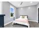 Bright bedroom with a ceiling fan features a comfortable bed with a view from the window at 320 Chickasaw Plum Dr, Holly Springs, NC 27540