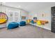 Comfortable bedroom featuring a hanging chair, stylish desk, and beanbag chairs for cozy relaxation at 320 Chickasaw Plum Dr, Holly Springs, NC 27540