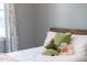 Close-up on a cozy bed with assorted stuffed animals and soft pillows near a window with sheer curtains at 320 Chickasaw Plum Dr, Holly Springs, NC 27540