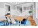 Open dining room showcasing a hardwood table, stylish chairs, and staircase adding architectural detail to the space at 320 Chickasaw Plum Dr, Holly Springs, NC 27540