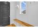 Convenient entryway with a wooden bench, coat hooks, and ample natural light at 320 Chickasaw Plum Dr, Holly Springs, NC 27540