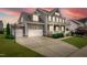 A charming home featuring a three-car garage, basketball hoop, and well-maintained lawn at 320 Chickasaw Plum Dr, Holly Springs, NC 27540