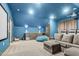 Inviting movie room featuring a projector screen, comfortable seating, and a convenient wet bar area at 320 Chickasaw Plum Dr, Holly Springs, NC 27540