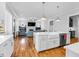 Spacious kitchen with a large island, modern appliances, and an open view into the living area at 320 Chickasaw Plum Dr, Holly Springs, NC 27540