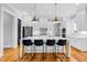 Modern kitchen with white cabinetry, stainless steel appliances, and large center island with seating at 320 Chickasaw Plum Dr, Holly Springs, NC 27540