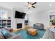 Spacious living room with a fireplace, built-in shelving, and hardwood floors, perfect for gatherings and relaxation at 320 Chickasaw Plum Dr, Holly Springs, NC 27540