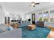Bright living room with stylish furniture, hardwood floors, and open concept to a modern kitchen at 320 Chickasaw Plum Dr, Holly Springs, NC 27540