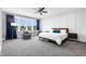 Expansive primary bedroom with large windows, sitting area, and plush carpeting at 320 Chickasaw Plum Dr, Holly Springs, NC 27540