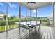 Relax on the screened porch, complete with ping pong table for entertainment at 320 Chickasaw Plum Dr, Holly Springs, NC 27540