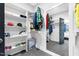 Organized walk-in closet featuring shelving, hanging rods, and access to the main bedroom at 320 Chickasaw Plum Dr, Holly Springs, NC 27540