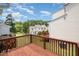 Outdoor wooden deck featuring dark wooden railings and view of the lush backyard and surrounding homes at 33 Grapevine Trl, Durham, NC 27707