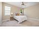 Cozy bedroom with neutral decor, carpet, ceiling fan and plenty of natural light from two windows at 33 Grapevine Trl, Durham, NC 27707