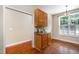 Dining area showcasing hardwood floors, a stylish light fixture, and ample cabinet space, creating a cozy space to enjoy meals at 33 Grapevine Trl, Durham, NC 27707