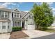 Charming home exterior showcasing a well-manicured lawn, garage, and inviting entryway at 33 Grapevine Trl, Durham, NC 27707
