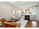 Bright living room with a cozy fireplace, hardwood floors, and neutral decor, perfect for relaxation and entertainment at 33 Grapevine Trl, Durham, NC 27707