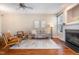 Cozy living room with hardwood floors, a fireplace, and tasteful decor, creating an inviting and comfortable space to unwind at 33 Grapevine Trl, Durham, NC 27707