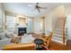 Open living room with fireplace, adjacent to the staircase and back patio, offering an inviting space for relaxation and easy access at 33 Grapevine Trl, Durham, NC 27707