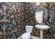Unique powder room featuring vibrant patterned wallpaper, pedestal sink, and toilet at 33 Grapevine Trl, Durham, NC 27707