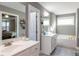 Bathroom featuring double sinks, white cabinets, and a separate tub at 333 Bald Head Island Dr, Garner, NC 27529