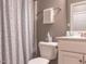 Cozy bathroom featuring a patterned shower curtain, toilet, and vanity at 333 Bald Head Island Dr, Garner, NC 27529