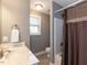Bathroom featuring a white vanity, window, tile floor, and shower with curtain at 333 Bald Head Island Dr, Garner, NC 27529