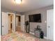 Bedroom with carpet and gray walls, featuring an ensuite bathroom, TV and an organized side table at 333 Bald Head Island Dr, Garner, NC 27529
