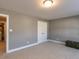 Bedroom with carpet and gray walls, featuring a closet and access to the bathroom at 333 Bald Head Island Dr, Garner, NC 27529