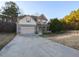 Inviting two-story home showcasing a spacious driveway, attached garage, and classic architecture at 333 Bald Head Island Dr, Garner, NC 27529