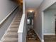 Bright hallway with staircase and hardwood floors, creating a welcoming and stylish entrance at 333 Bald Head Island Dr, Garner, NC 27529