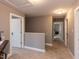 Upstairs hallway with carpet featuring bedrooms, with neutral paint at 333 Bald Head Island Dr, Garner, NC 27529