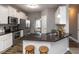 Modern kitchen with island seating, granite countertops, and stainless steel appliances at 333 Bald Head Island Dr, Garner, NC 27529