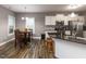 Well-lit kitchen featuring a dining area, granite countertops, and stainless steel appliances at 333 Bald Head Island Dr, Garner, NC 27529