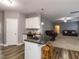 Open-concept kitchen with granite countertop island and seating, seamlessly flowing into the living area at 333 Bald Head Island Dr, Garner, NC 27529