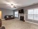 Spacious living room with ceiling fan, fireplace, and large windows, offering natural light at 333 Bald Head Island Dr, Garner, NC 27529