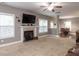 Spacious living room with a fireplace, large TV, and bright windows at 333 Bald Head Island Dr, Garner, NC 27529