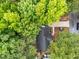Aerial view of the home nestled among lush trees, with a driveway and landscaped front yard at 3608 Meadow Creek Ln, Raleigh, NC 27616