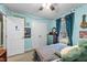 Bright bedroom with blue walls, string lights, and a cozy atmosphere for children at 3608 Meadow Creek Ln, Raleigh, NC 27616