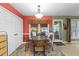 Bright dining area with a glass table, wicker chairs, and natural light from the windows at 3608 Meadow Creek Ln, Raleigh, NC 27616
