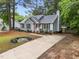 Charming one-story home with a landscaped front yard, inviting walkway, and classic architectural details at 3608 Meadow Creek Ln, Raleigh, NC 27616