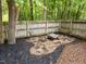 Cozy backyard fire pit area with stone ground covering, seating and wooden fence surround at 3608 Meadow Creek Ln, Raleigh, NC 27616