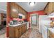 Practical kitchen with wooden cabinetry, white appliances, and convenient access to the living spaces at 3608 Meadow Creek Ln, Raleigh, NC 27616
