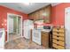 Traditional kitchen featuring white appliances, wood cabinetry, and access to another room at 3608 Meadow Creek Ln, Raleigh, NC 27616