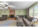 Spacious living room with a brick fireplace, comfortable seating, and natural light at 3608 Meadow Creek Ln, Raleigh, NC 27616